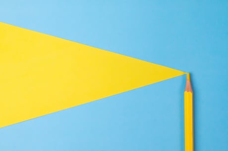A yellow pencil crayon on a blue background.