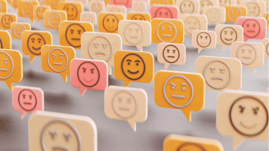 Emoji speech bubbles display various facial expressions, floating in clusters within a soft-focus environment, depicting a mix of emotions like happiness, anger, sadness, and surprise.